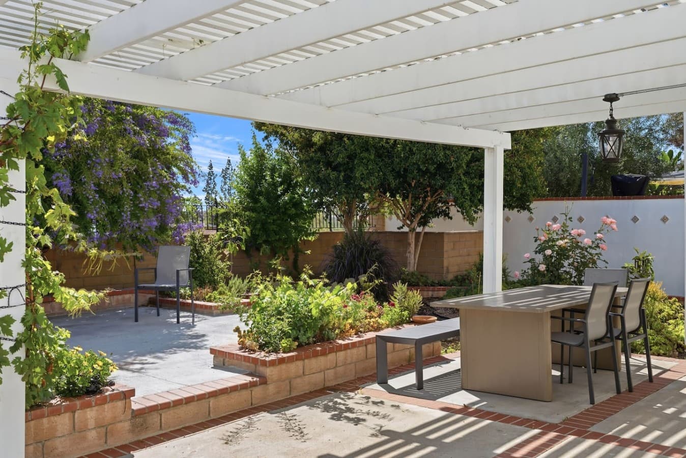 Private backyard patio with shaded seating and outdoor space.