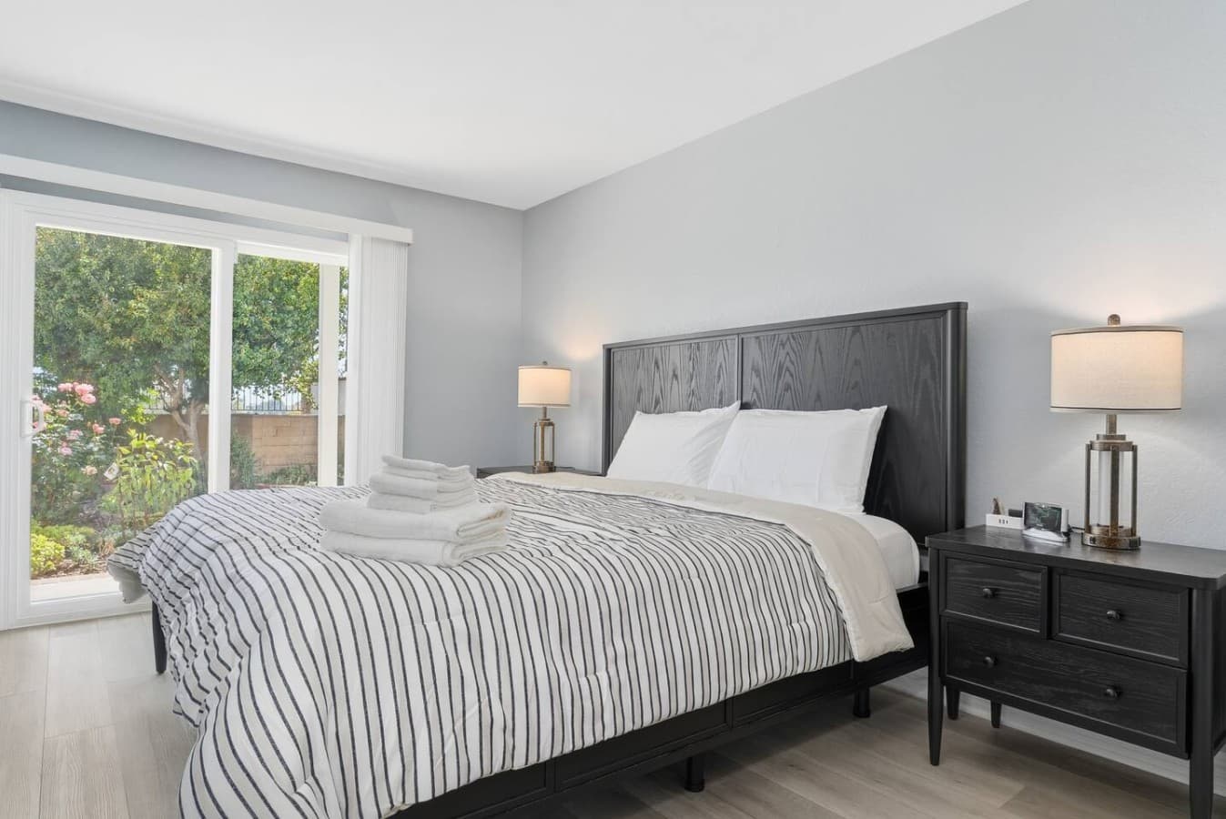 Comfortable primary bedroom with soft linens and backyard access.