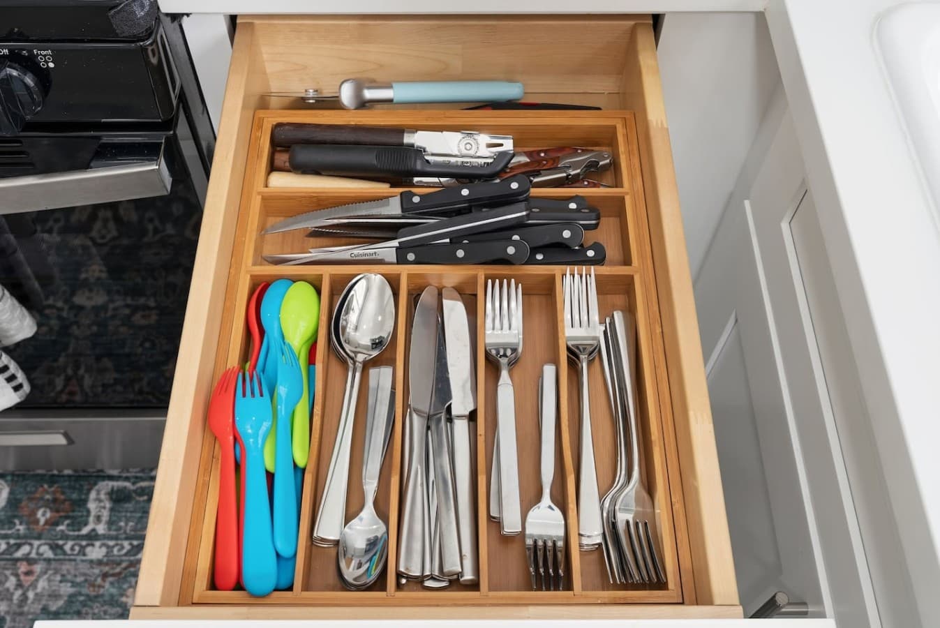 Organized utensil drawer with everything needed for dining.