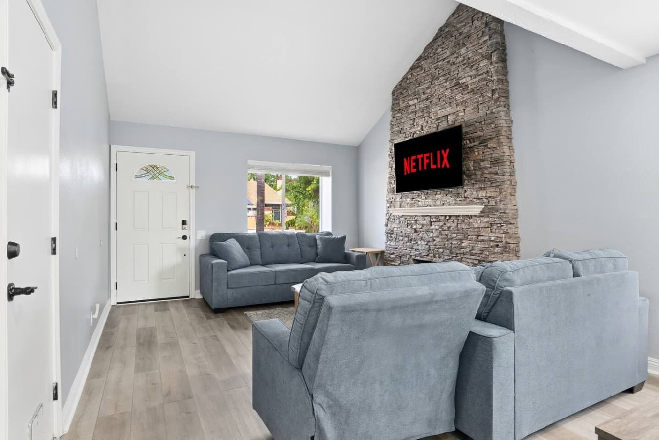 Spacious living room with soaring ceilings and a cozy fireplace.