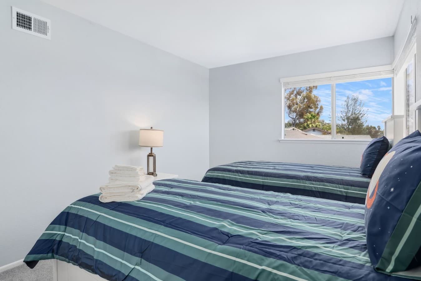 Cozy twin bedroom filled with natural light.
