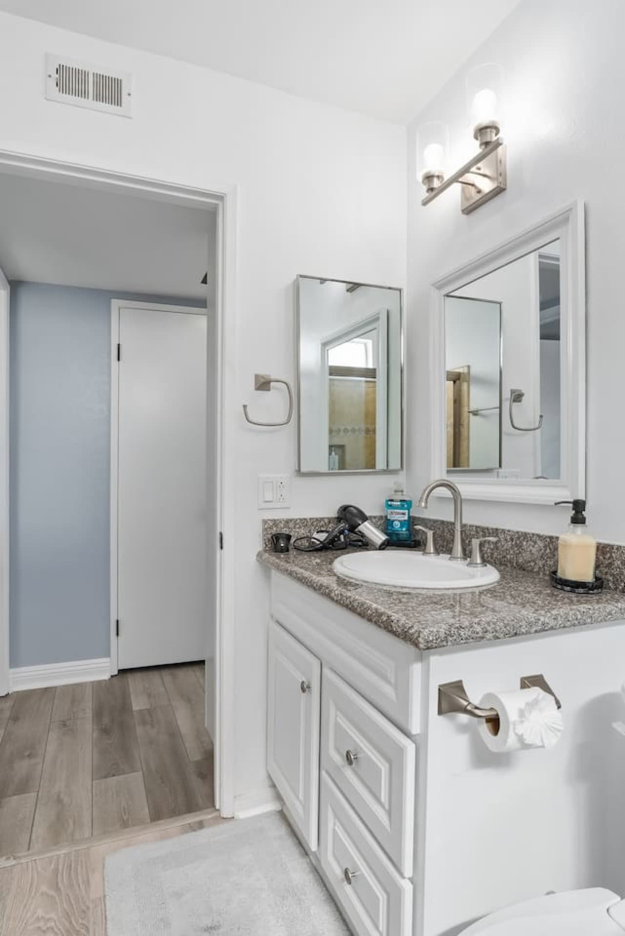 Full bathroom with granite countertops and fresh essentials.