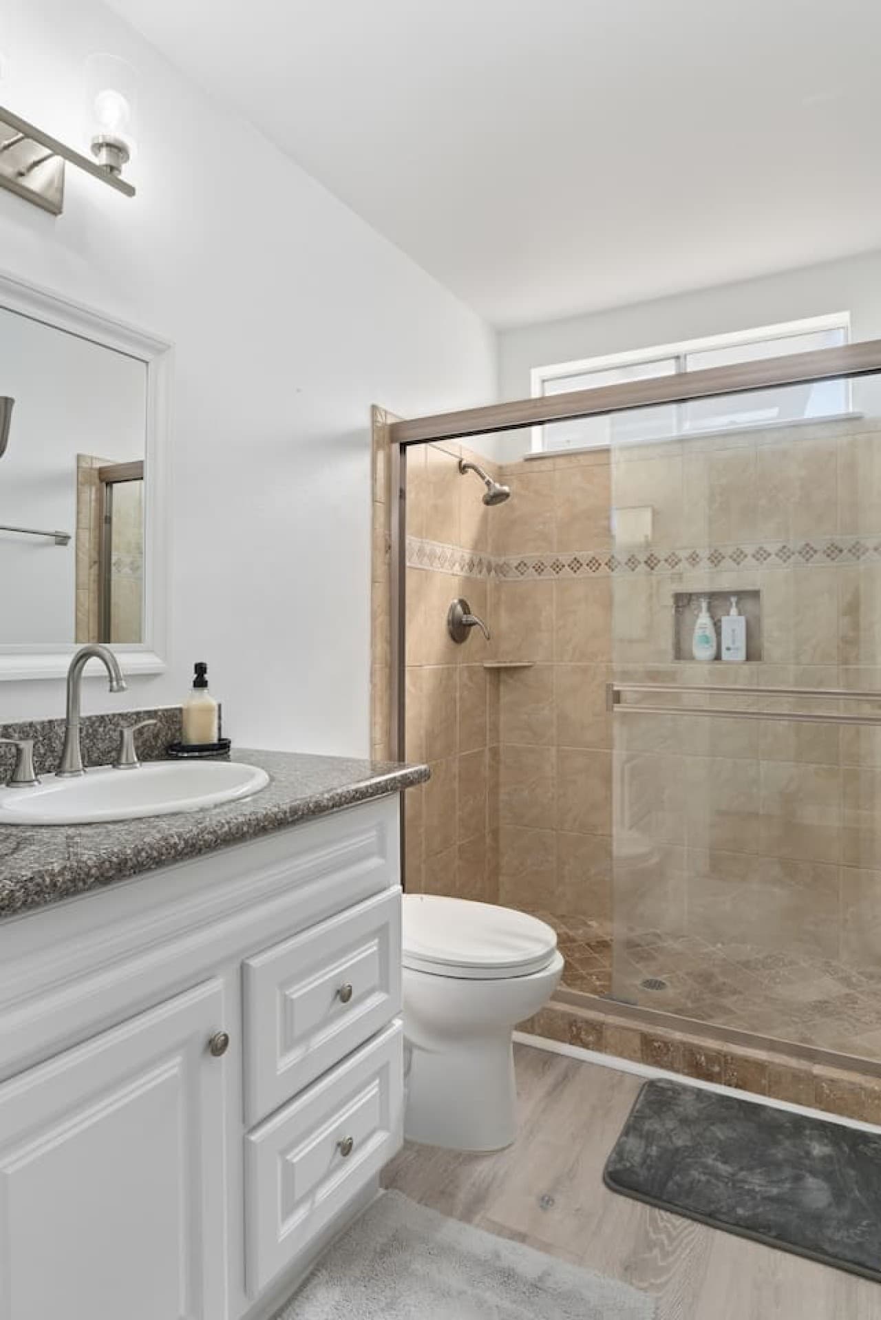 Spacious bathroom featuring a walk in shower and ample counter space.
