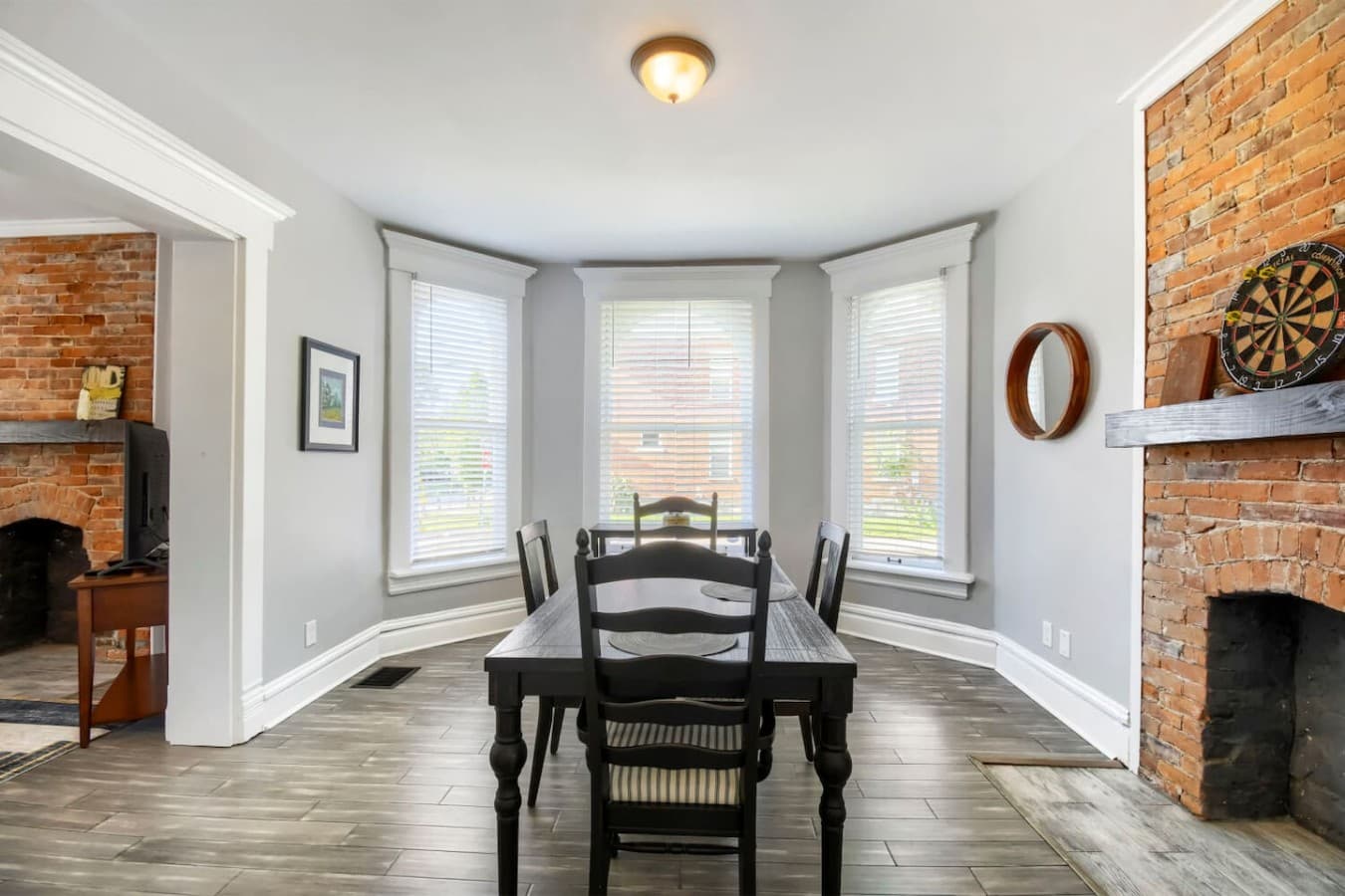 Cozy dining area surrounded by beautiful bay windows creating a bright and welcoming setting.