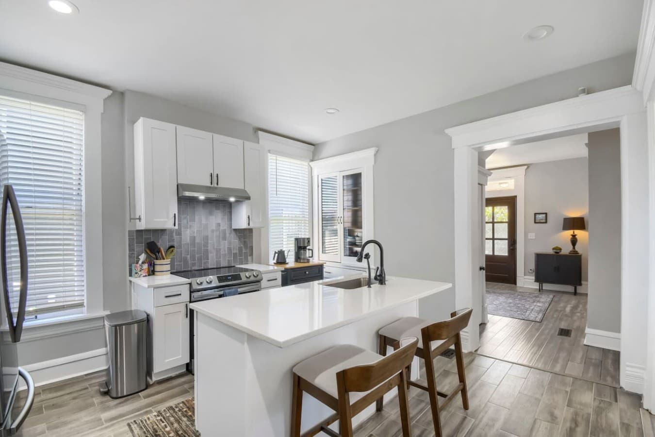 Bright, fully equipped kitchen with a spacious island, bar seating, and everything you need to prepare meals.