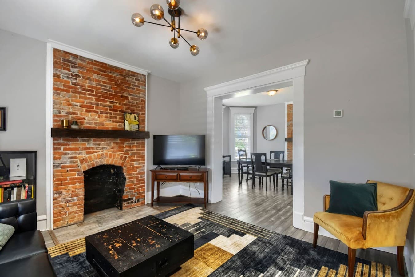 Relax in the inviting living room featuring a smart TV and open flow into the dining area for easy gathering.