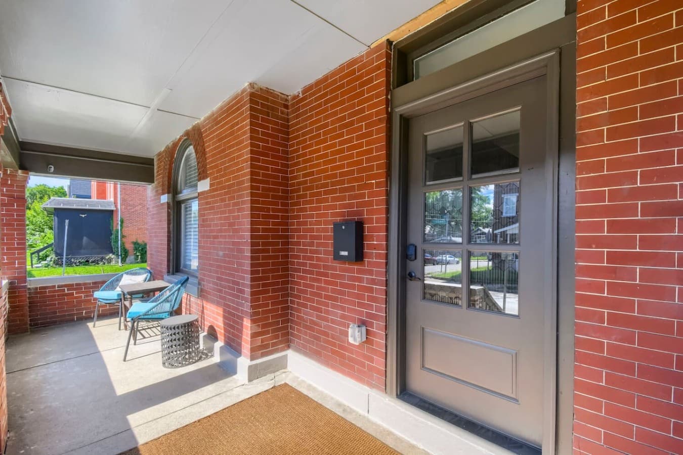 Covered front porch with comfortable seating offers the perfect spot to enjoy your morning coffee or unwind.
