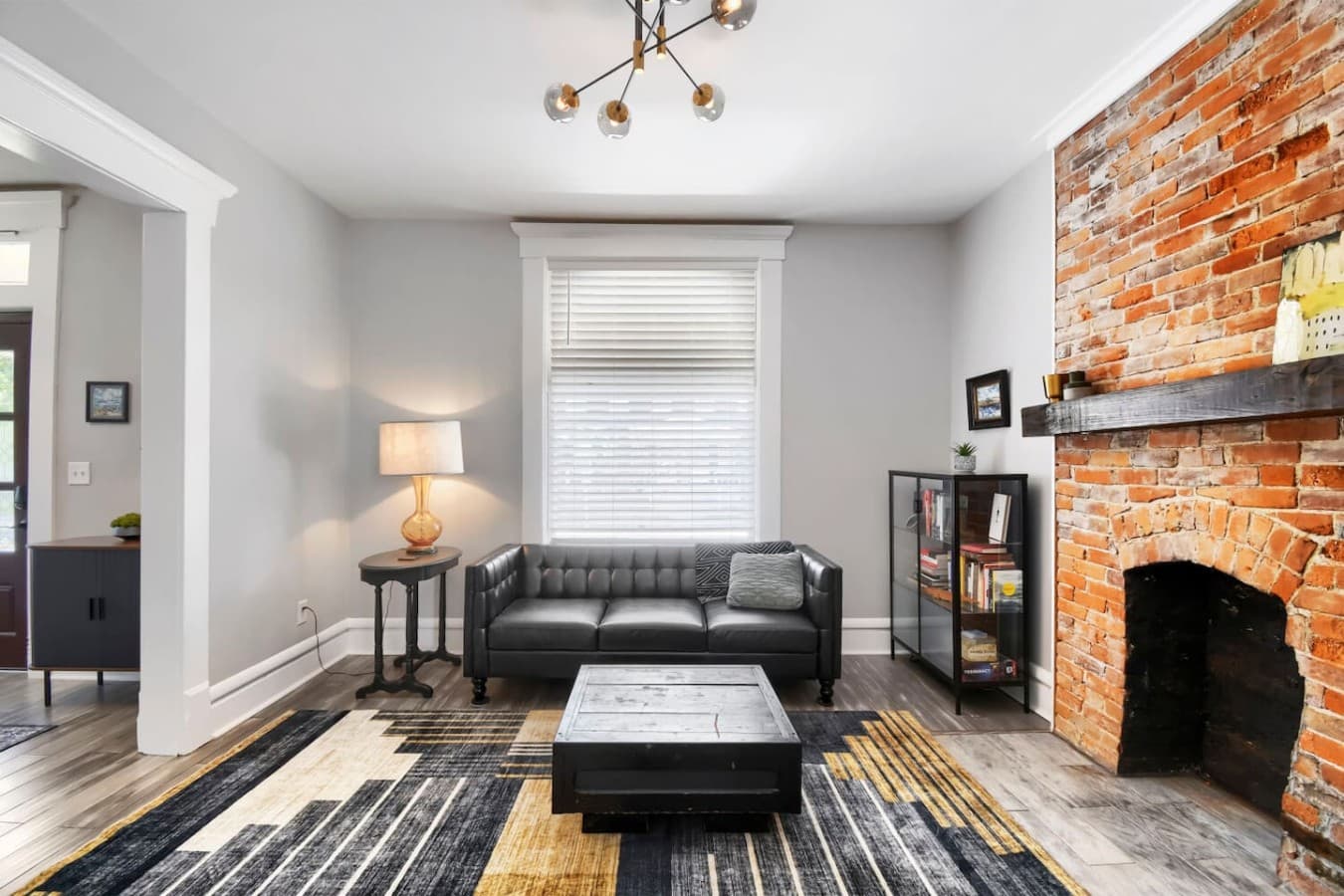 Unwind on the comfortable sofa with plenty of natural light, stylish furnishings, and a cozy atmosphere.