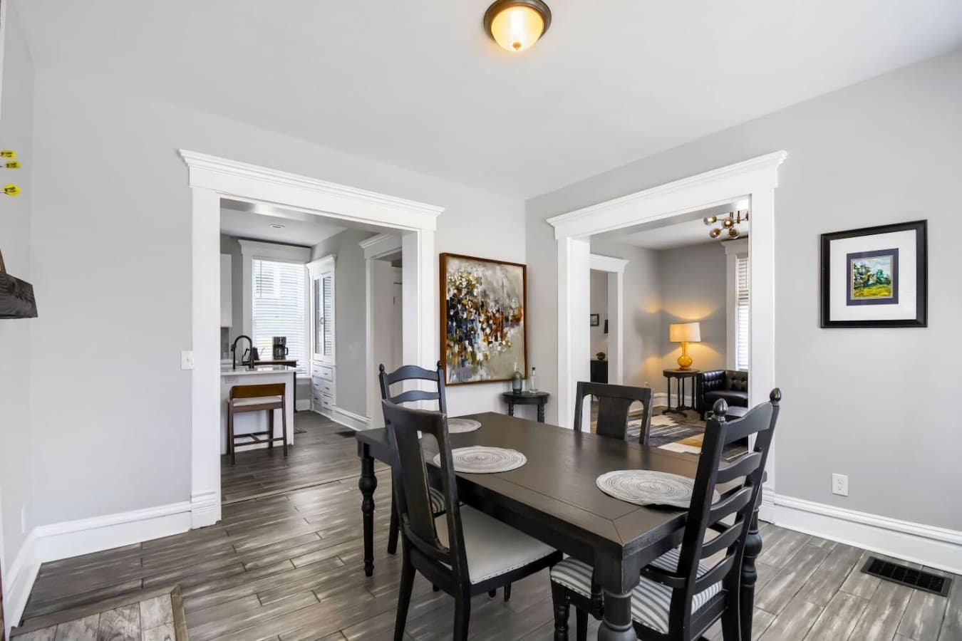 Spacious dining room conveniently connected to the living room, kitchen, and entryway.