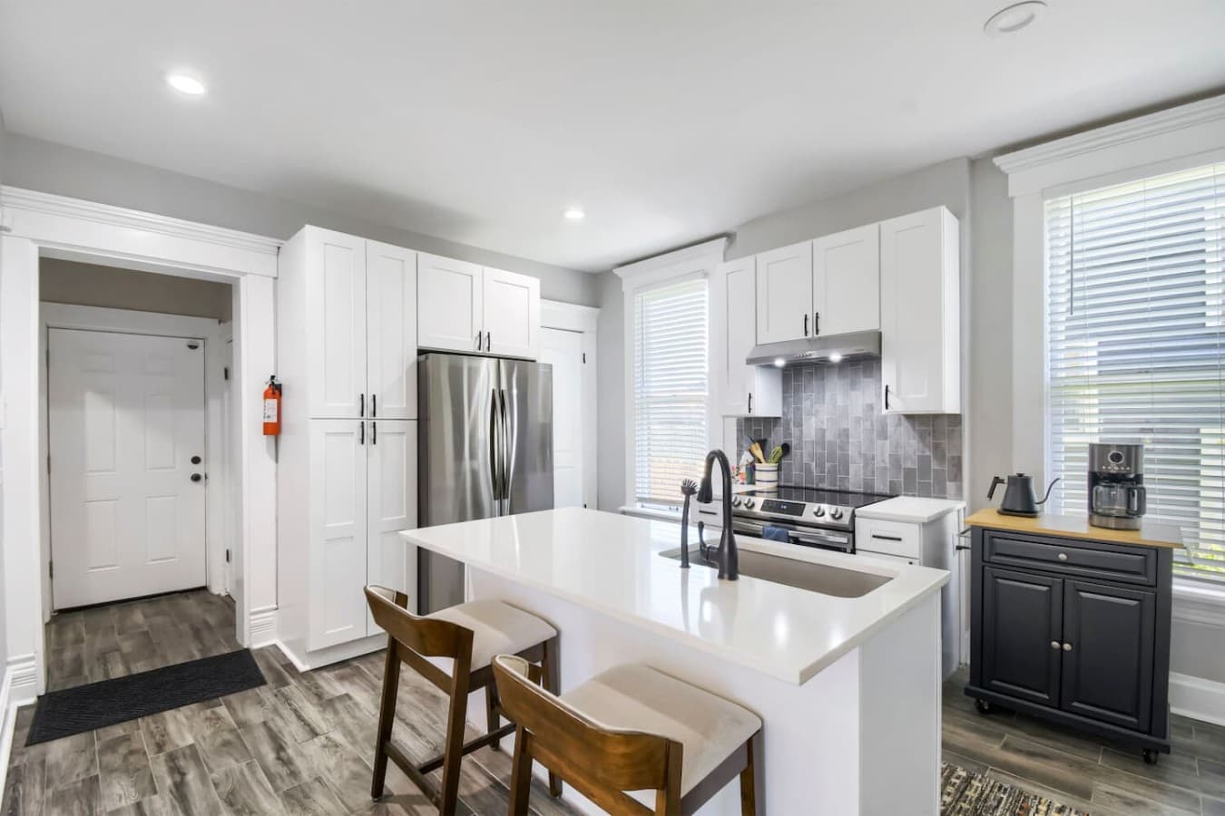 Modern kitchen featuring stainless steel appliances, generous counter space, and a large island for cooking and gathering.