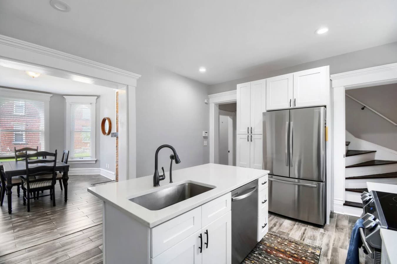 Enjoy the convenience of a stylish kitchen with a large refrigerator, deep sink, and ample space for meal prep.