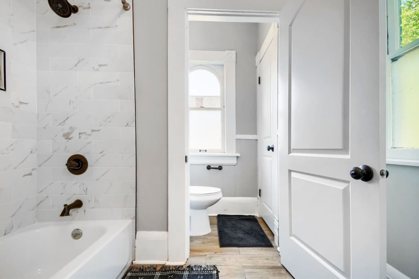Full bathroom featuring a shower and tub combination with a separate vanity area for added convenience.