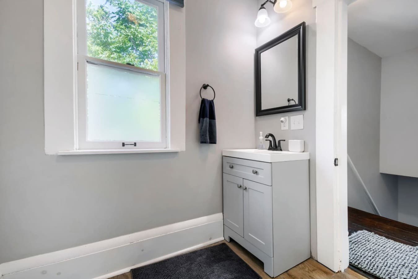 Bright bathroom with a modern vanity, large mirror, and natural light for a fresh start to your day.