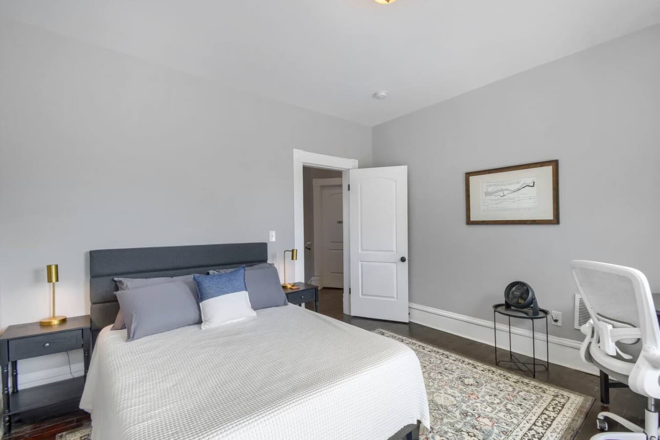 Unwind in this bright and inviting bedroom with cozy furnishings and plenty of space to settle in.