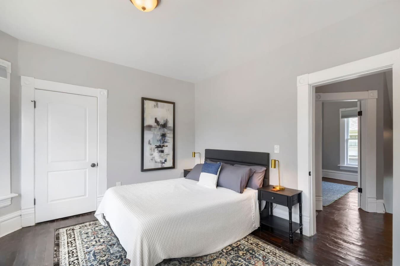 Peaceful bedroom with a plush bed, stylish décor, and bedside lighting for a restful night's sleep.