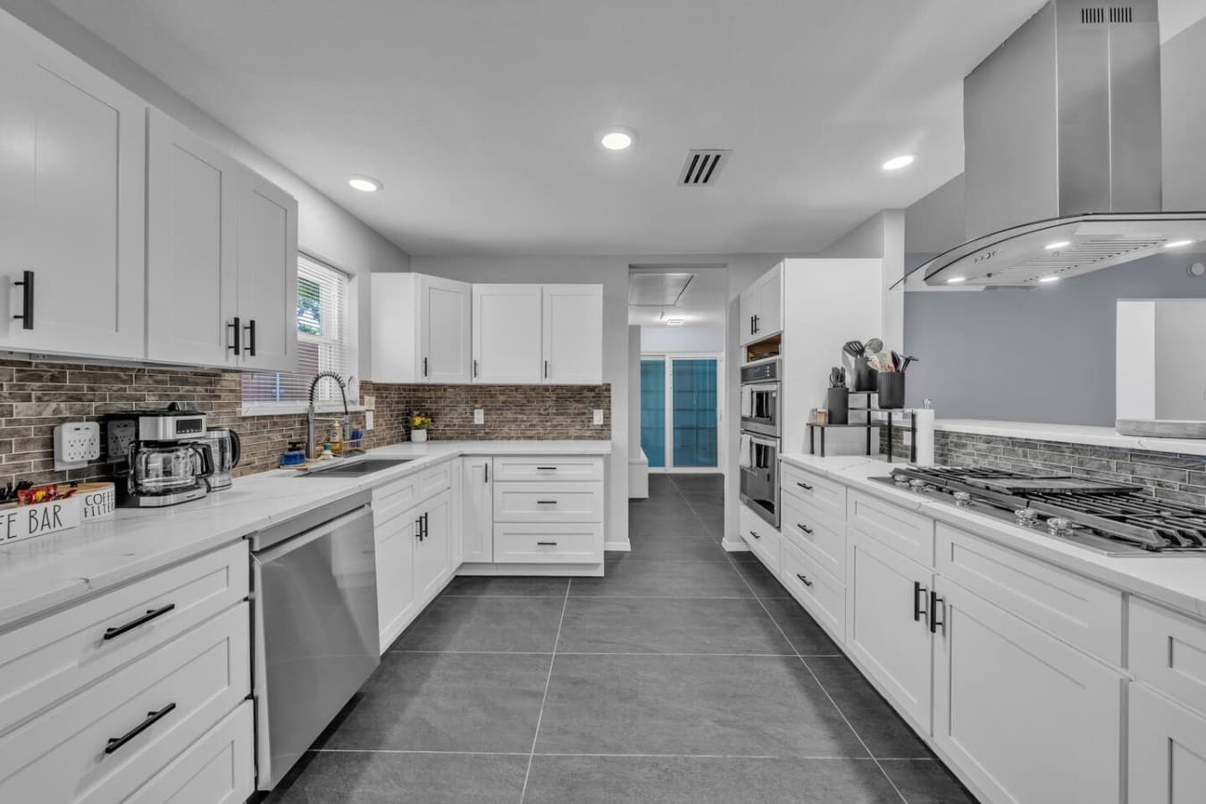 Bright and modern kitchen with generous counter space, ample storage, and an open, functional layout.