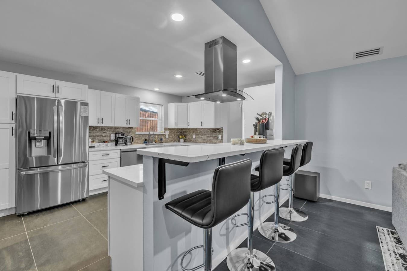 Fully equipped chef’s kitchen with a spacious island and bar seating for casual meals and conversation.