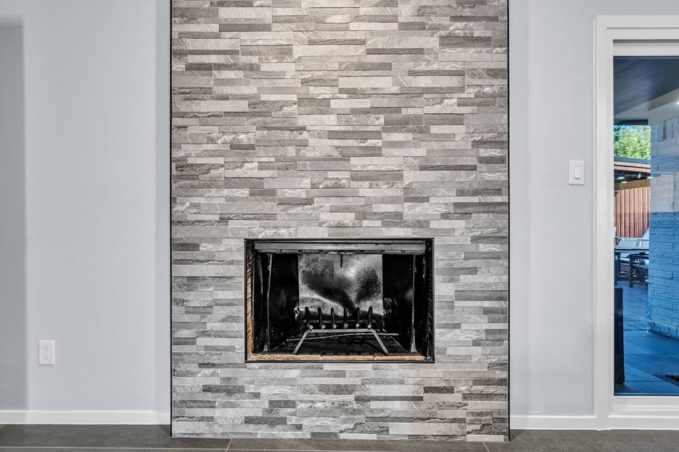 Contemporary stone fireplace creating a warm focal point and inviting atmosphere for cozy evenings indoors.