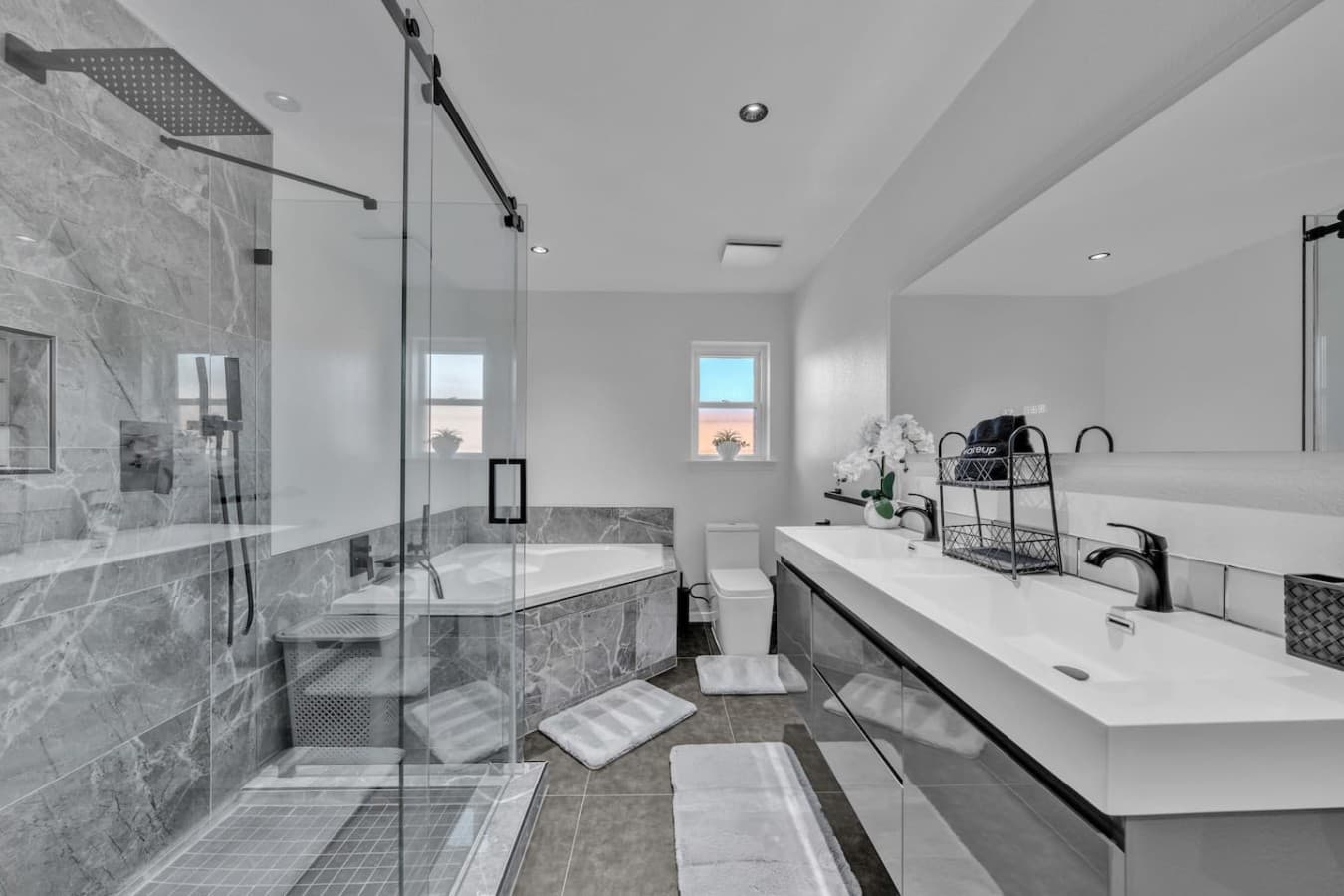 Spa inspired primary bathroom featuring a double vanity, soaking tub, and spacious walk in shower.