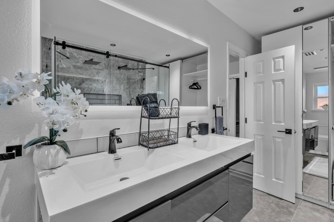 Elegant dual sink vanity with generous counter space and a large mirror for added convenience.
