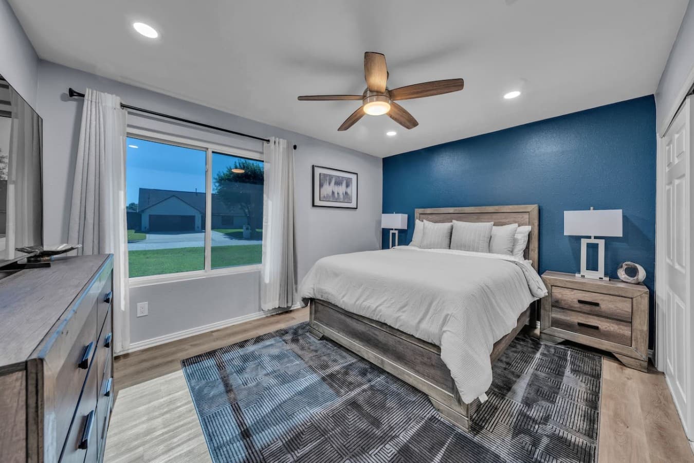 Comfortable bedroom with a plush bed, stylish accents, and plenty of natural light for a relaxing stay.