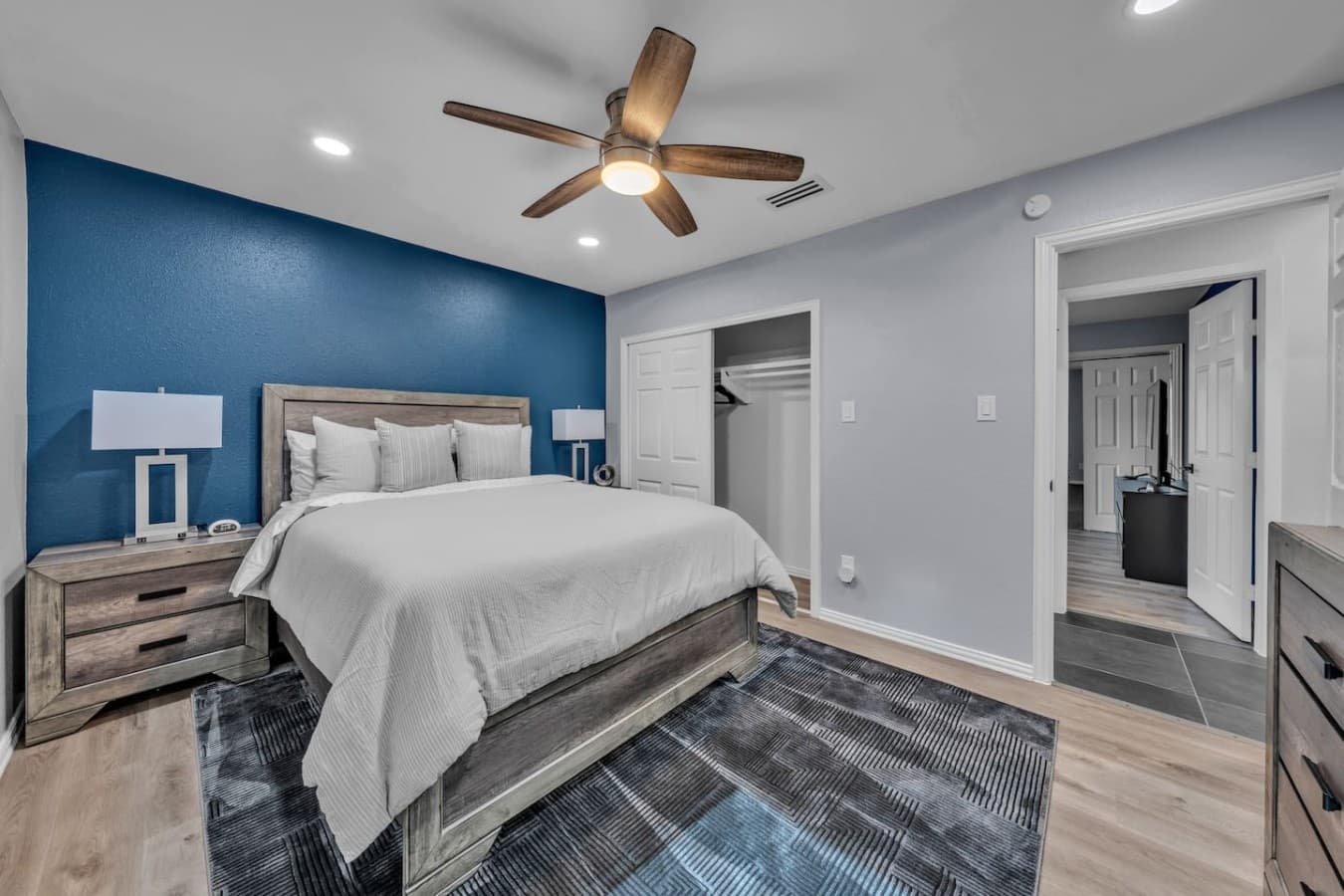 Thoughtfully designed retreat featuring cozy bedding, modern finishes, and easy access to the adjoining spaces.
