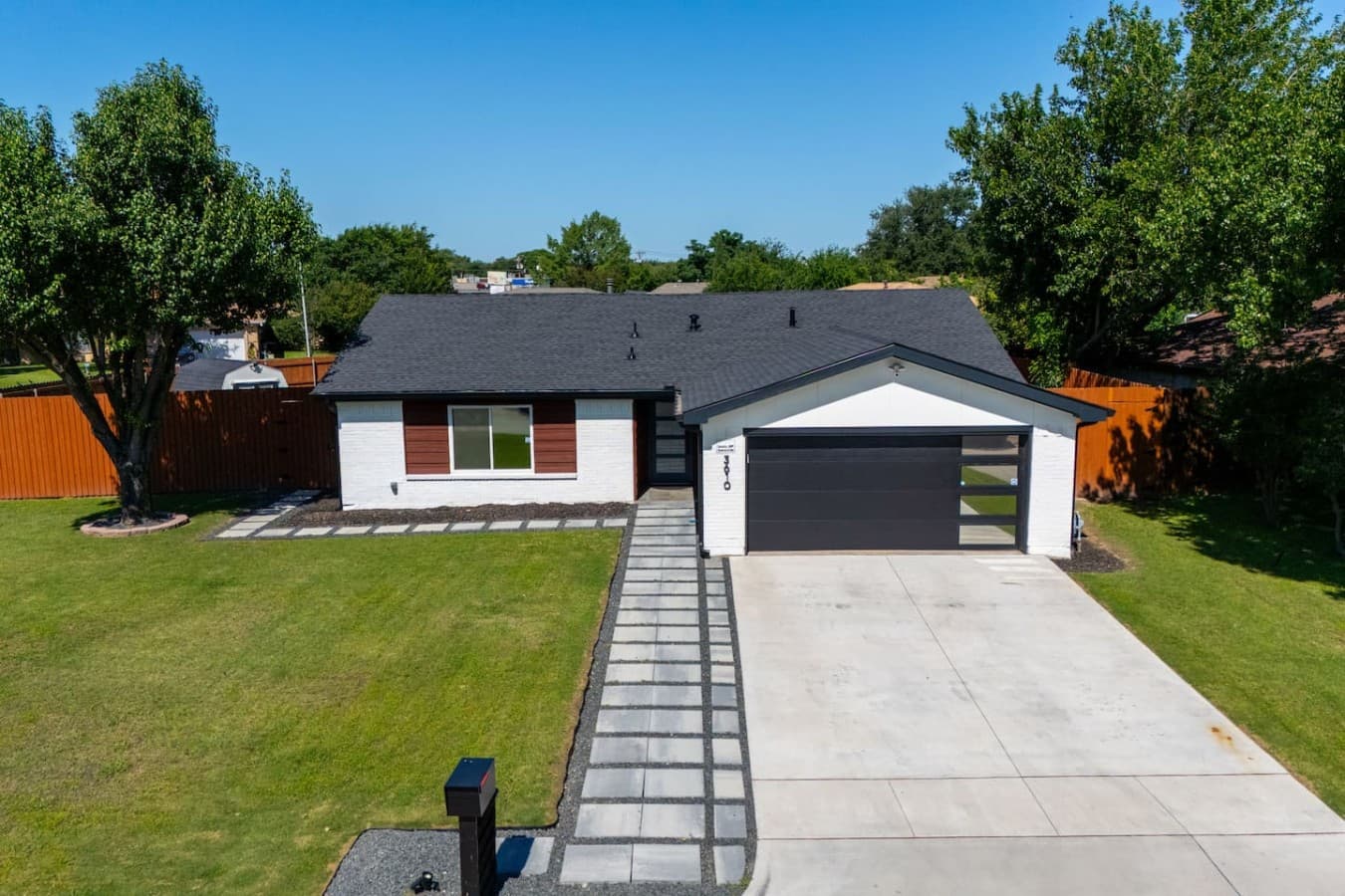 Contemporary single story home with ample parking and a clean, inviting exterior design.
