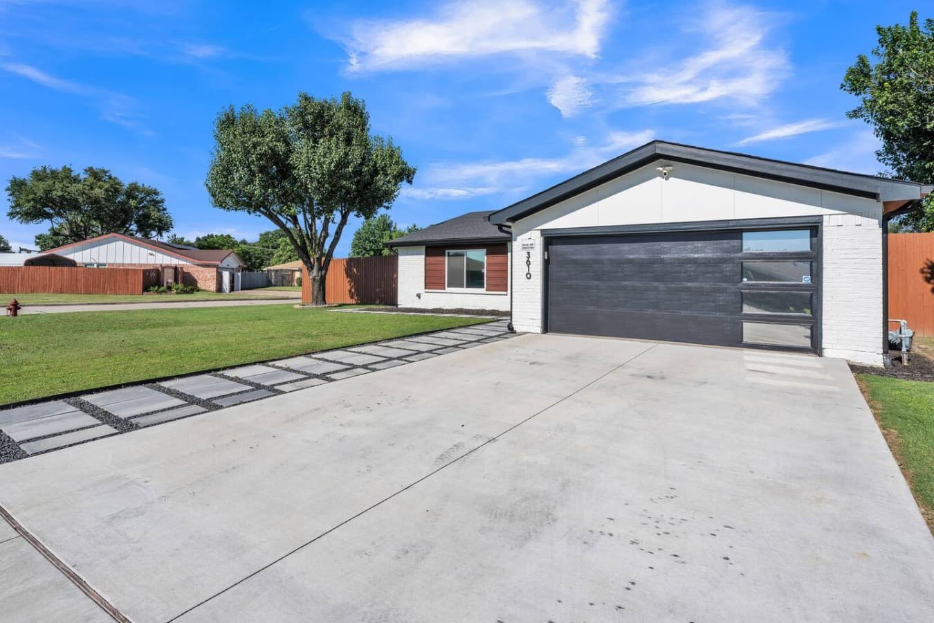 Spacious driveway with ample parking and a welcoming entrance to your home away from home.