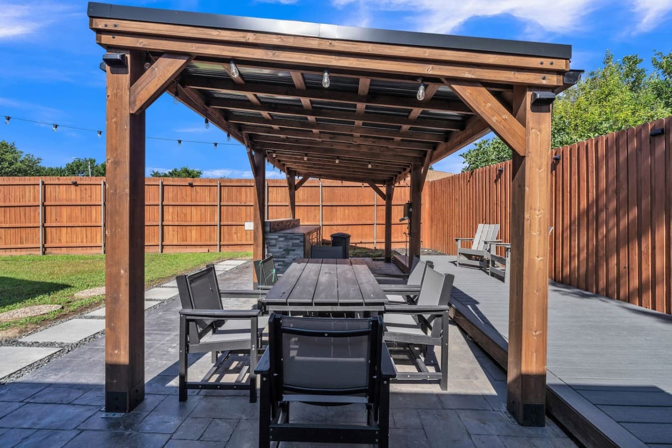 Enjoy al fresco meals and outdoor gatherings in this beautifully designed covered patio space.