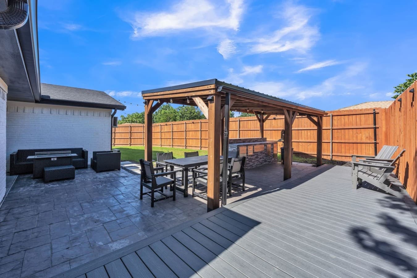 Expansive backyard featuring a covered pavilion, outdoor dining area, and plenty of space to relax and play.