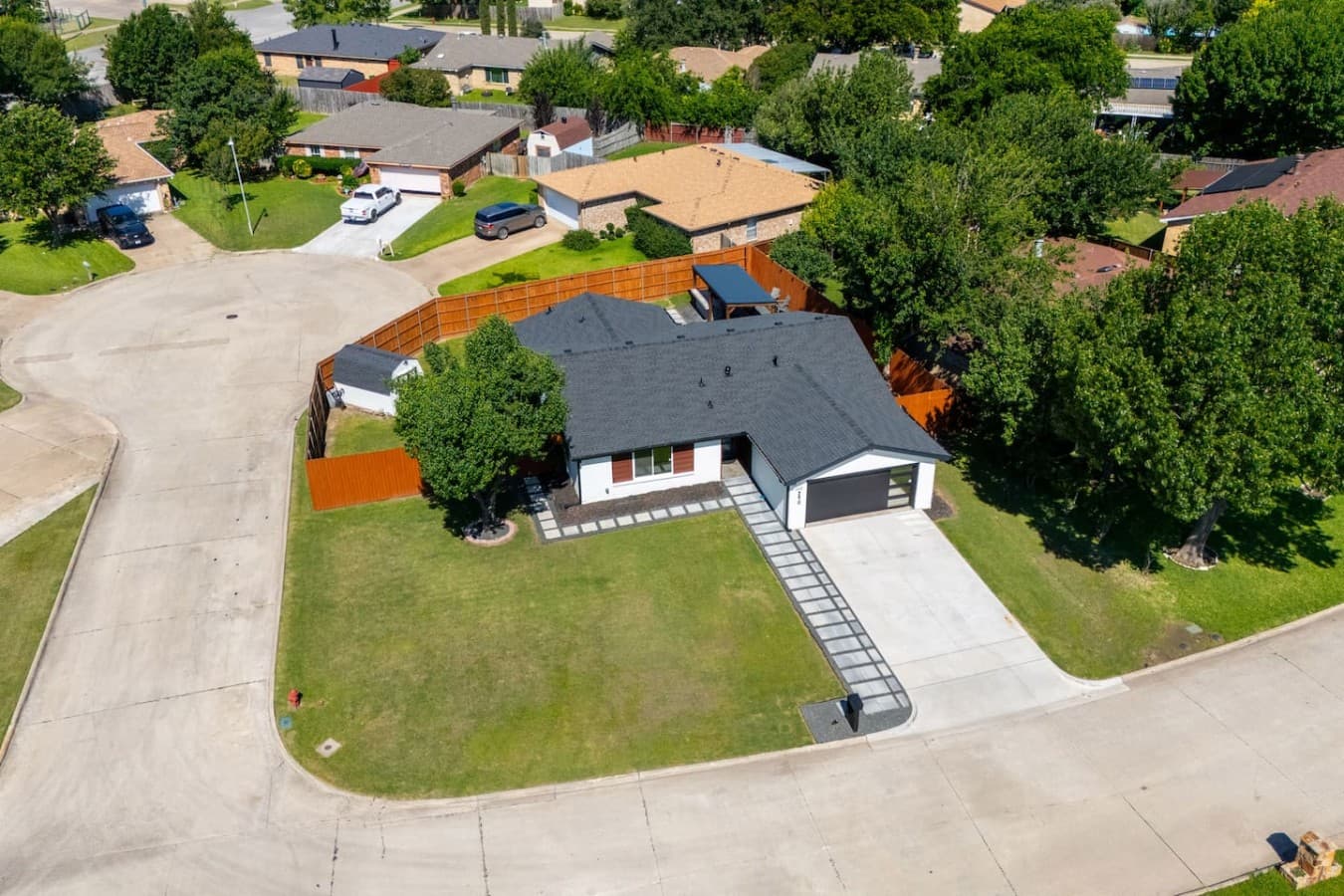 Aerial perspective highlighting the home's generous outdoor space, private backyard, and prime corner location.