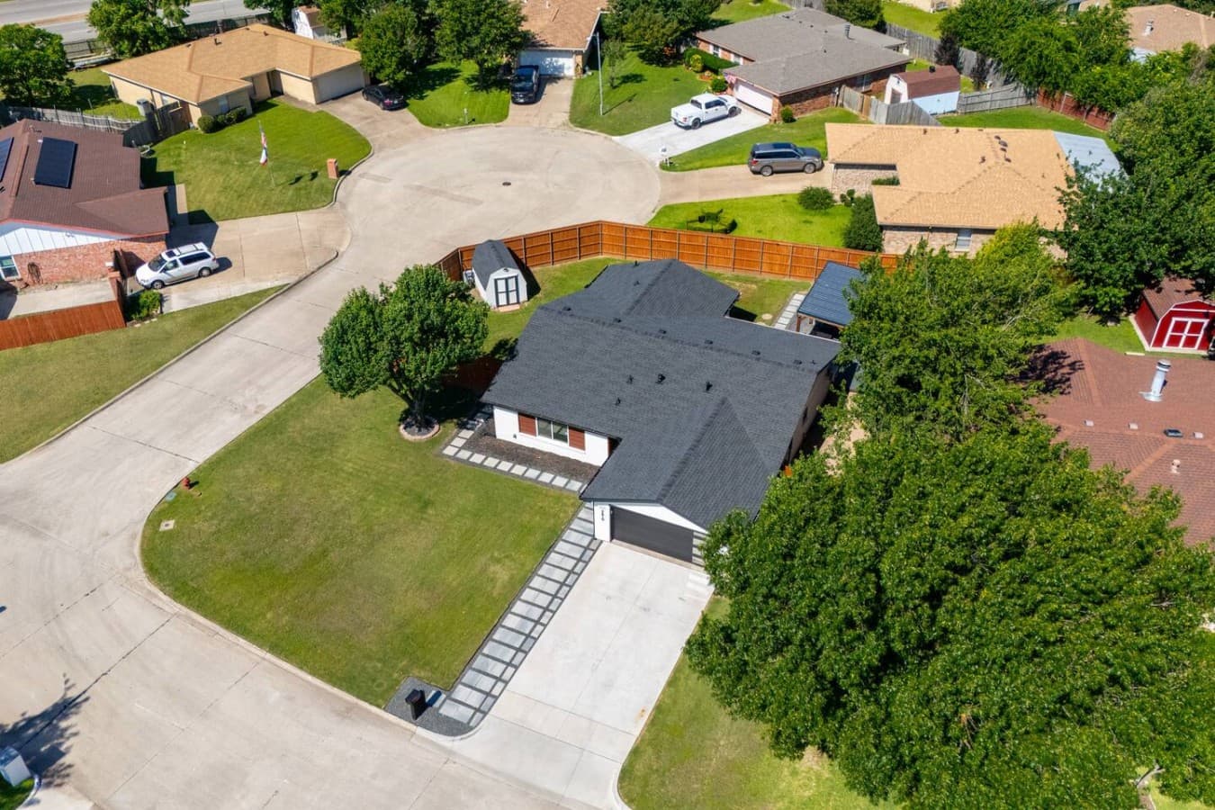 Aerial view showcasing the home's spacious corner lot, expansive yard, and private fenced outdoor spaces.