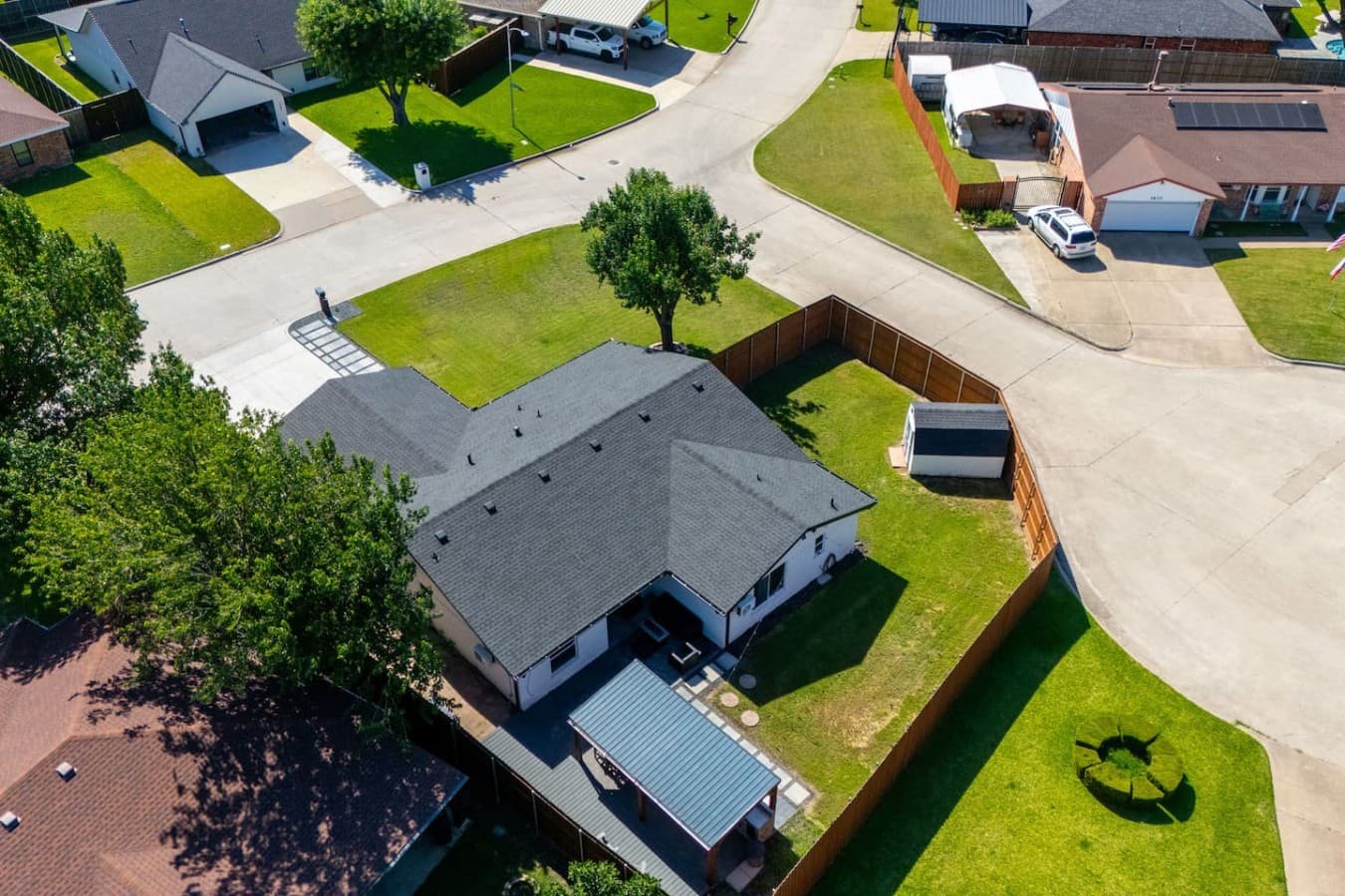 Bird's eye perspective highlighting the covered patio, large backyard, and thoughtfully designed outdoor entertaining areas.