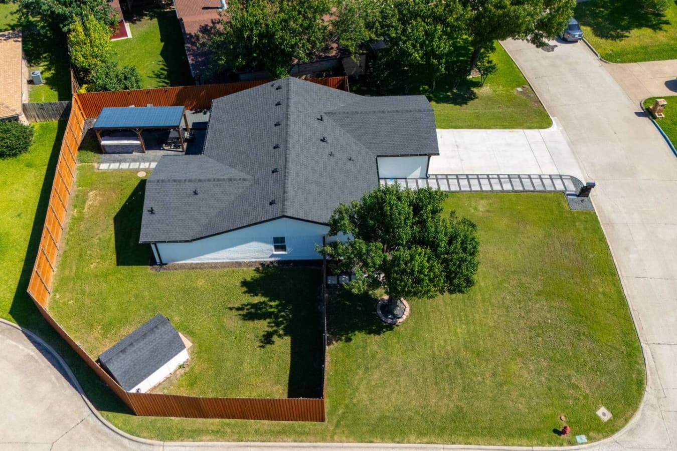 Elevated view of the oversized lot featuring open green space, mature trees, and a layout designed for comfort and convenience.
