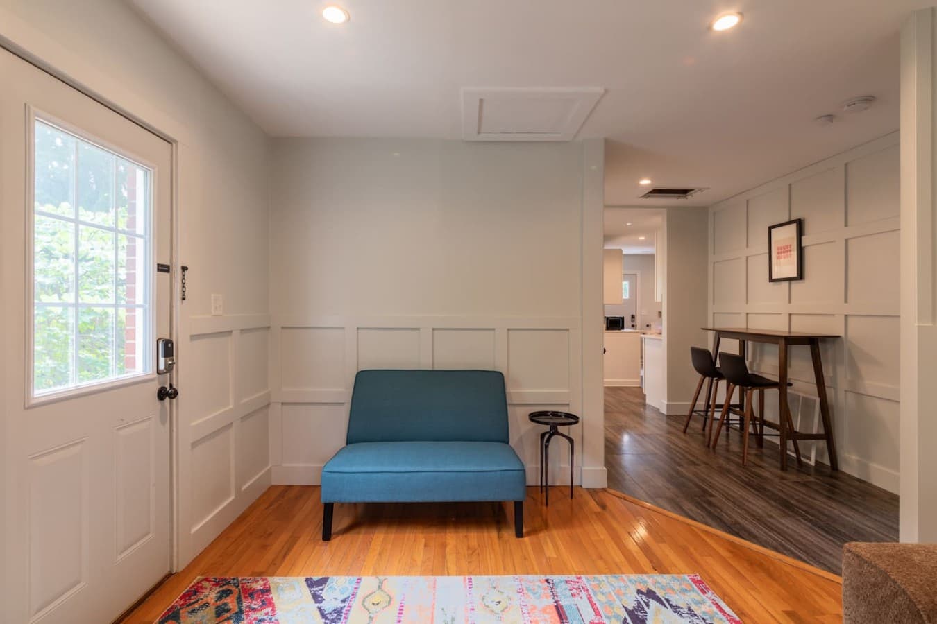 Entryway lounge nook with stylish bench seating and easy access to the main living spaces.
