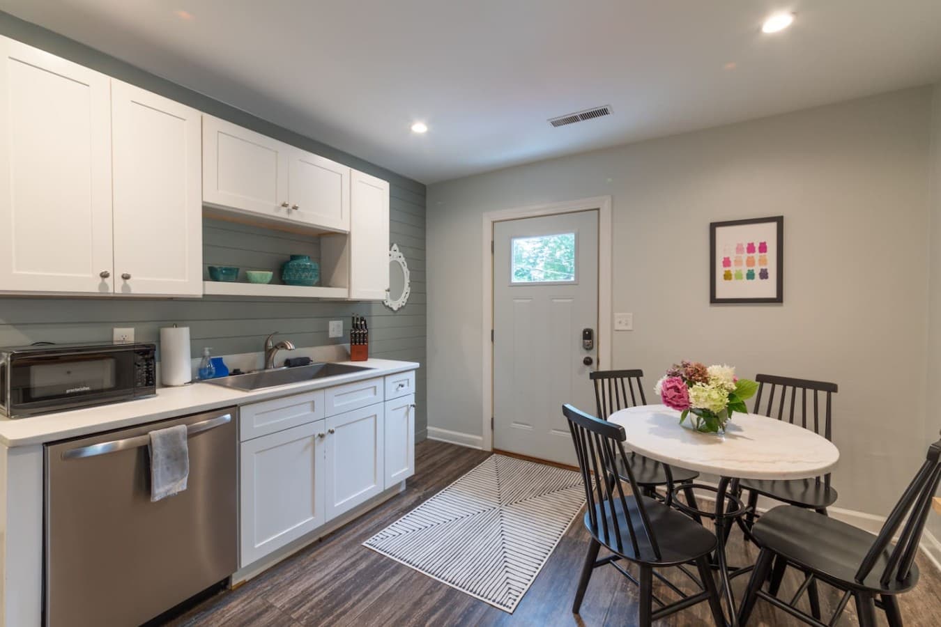Bright eat in kitchen with plenty of counter space and seating for shared meals.