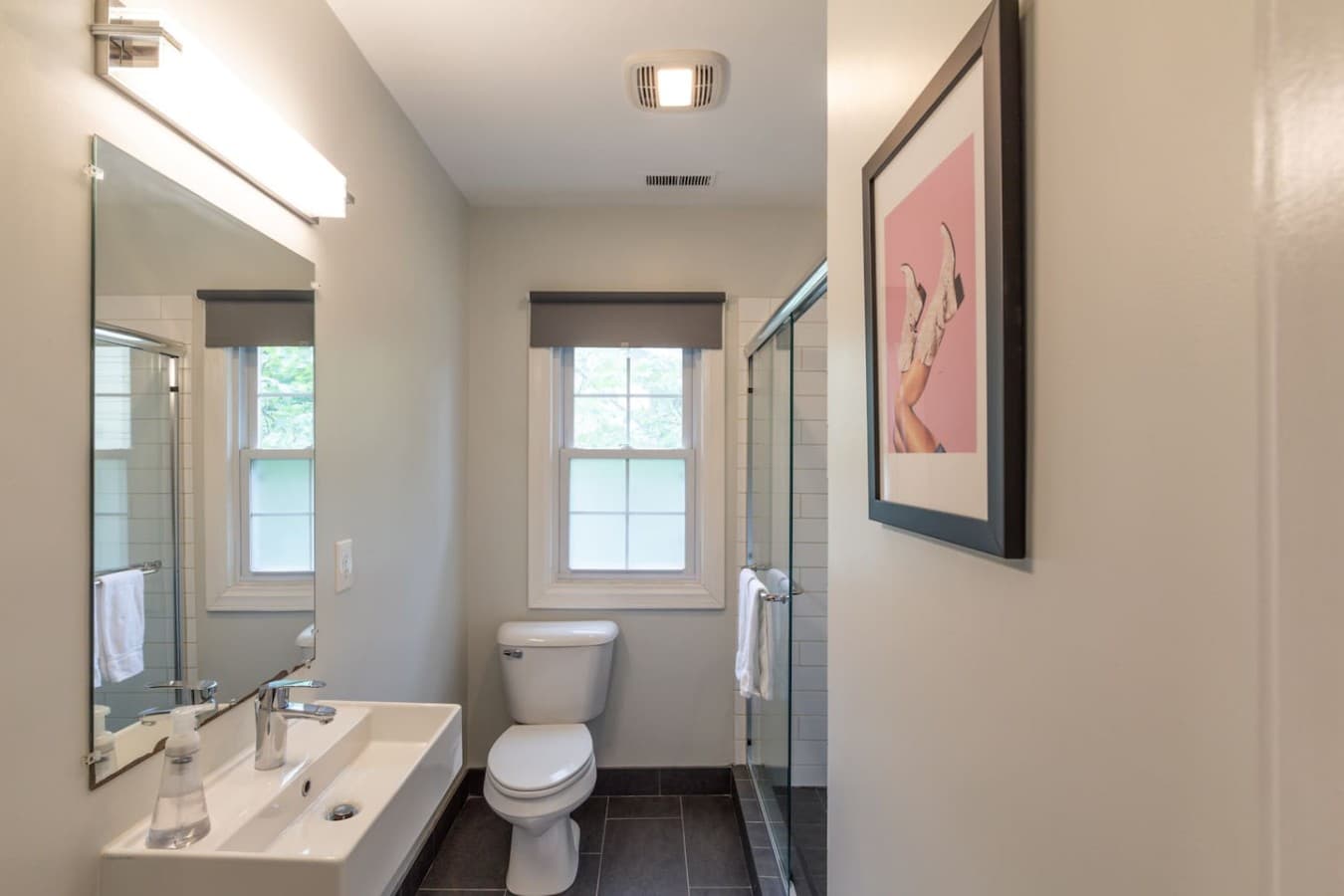Clean and modern bathroom with a glass enclosed shower and bright natural light.