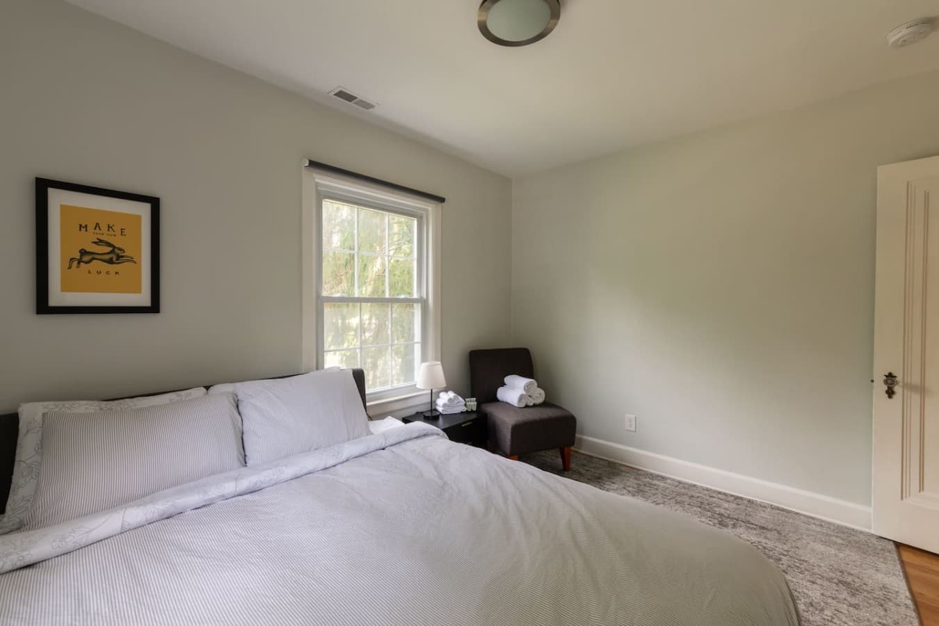 Comfortable bedroom with soft linens and plenty of natural light.
