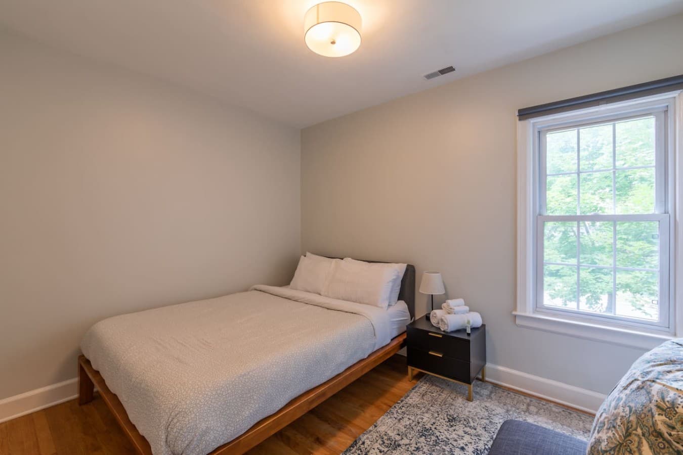 Cozy bedroom with soft linens and a bright window side retreat.