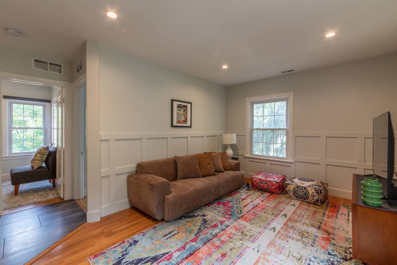 Spacious gathering space with plush sofa and large window views.