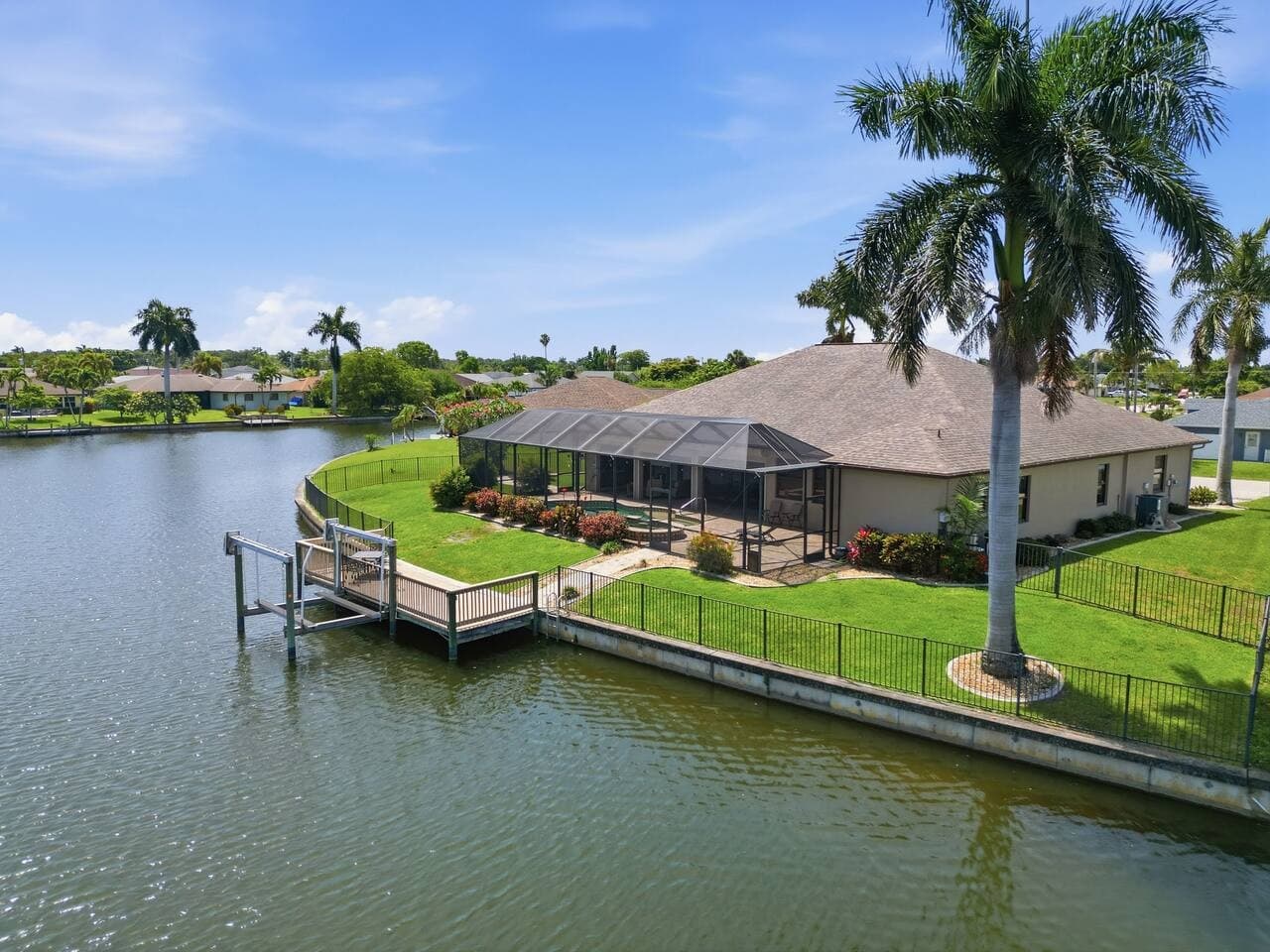 Waterfront backyard with private dock access and peaceful canal views throughout the property.