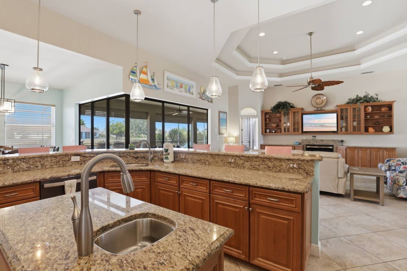 Fully equipped kitchen with granite countertops and open views into the living room.