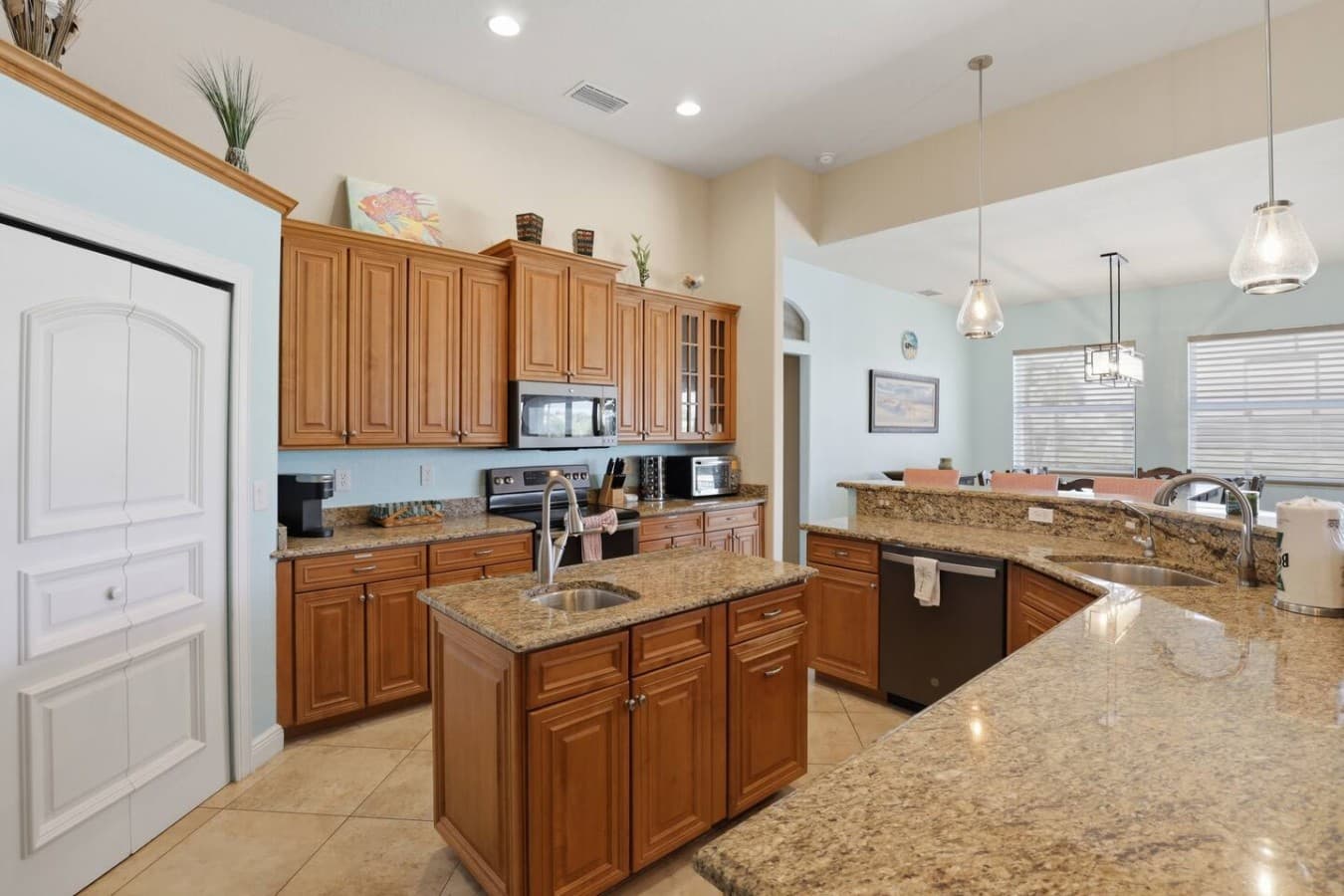 Spacious kitchen with stainless steel appliances and a large center island for gathering.