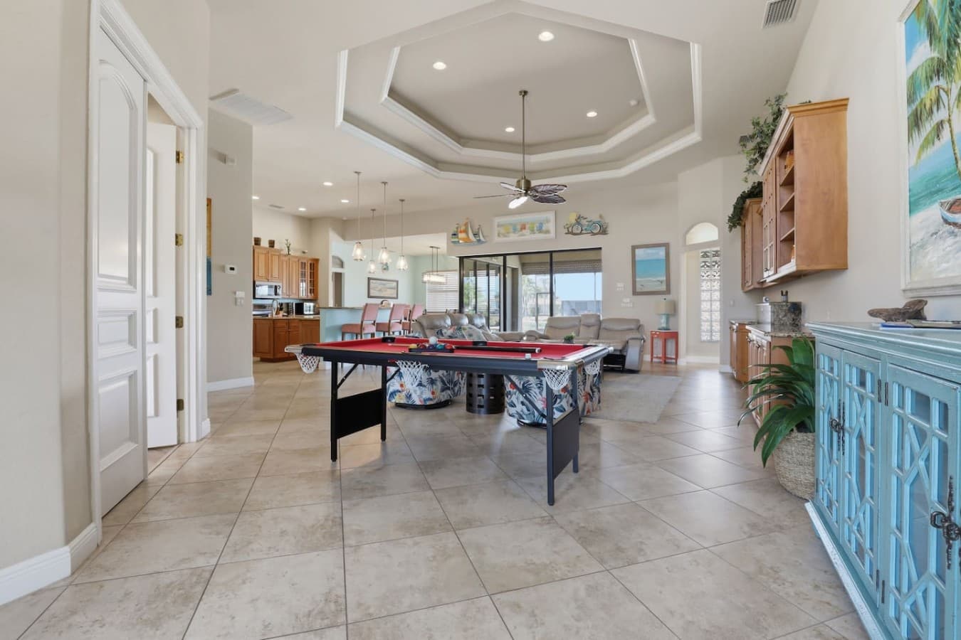 Open entertainment area featuring pool table and easy flow between the kitchen and living spaces.