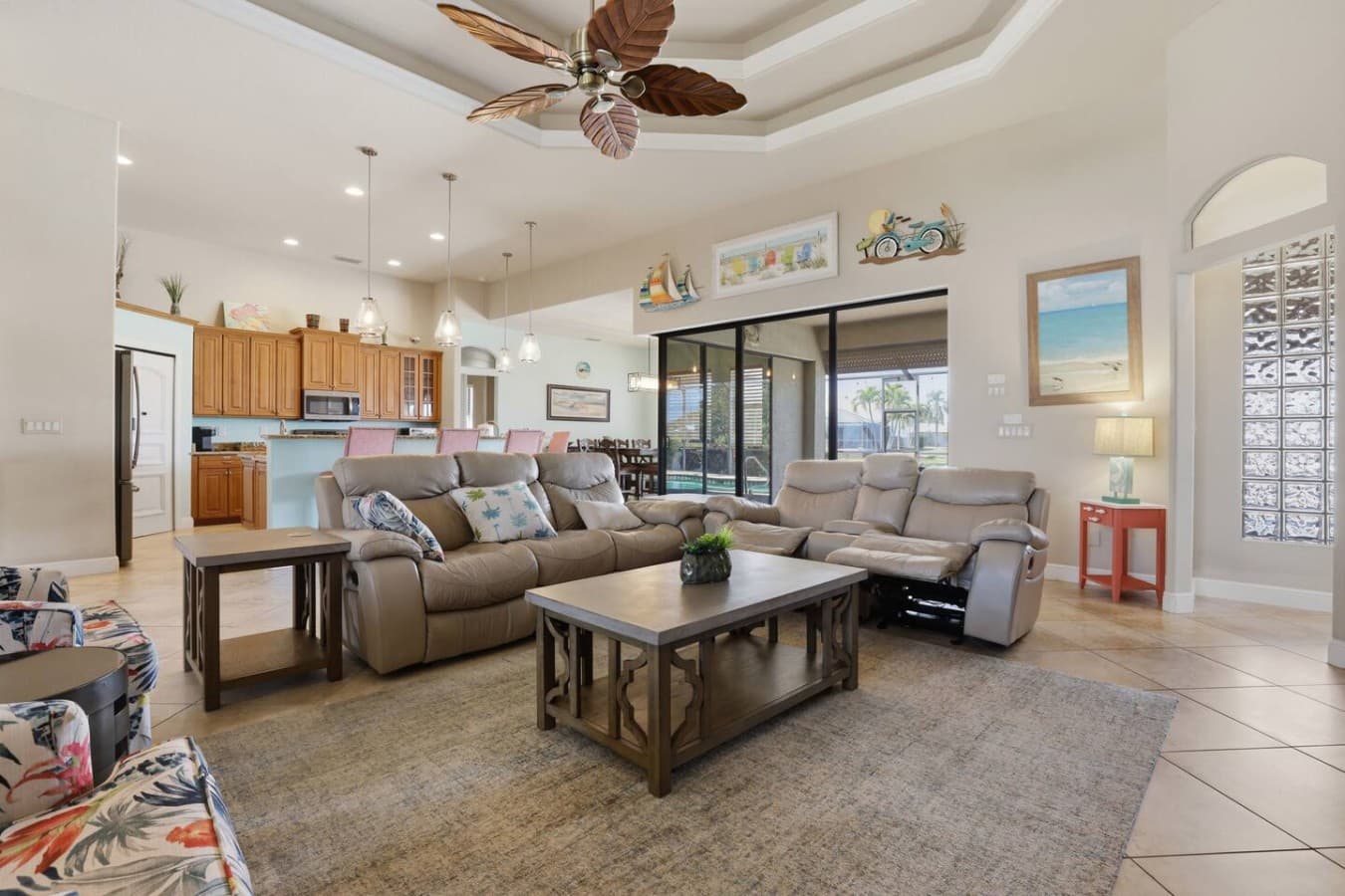 Spacious open concept living room with comfortable seating and natural light throughout.