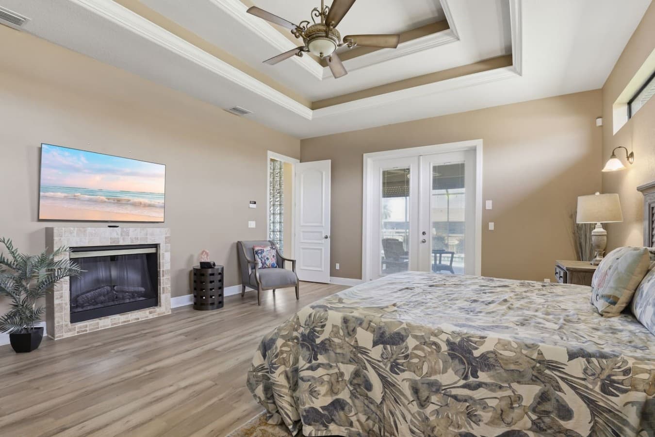 Private primary suite featuring a fireplace, cozy seating area, and ensuite access.