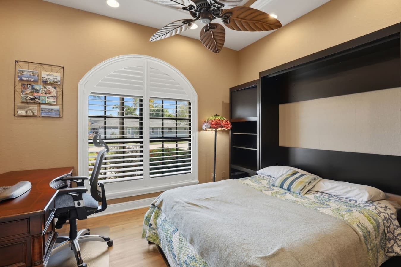 Private guest bedroom with workspace setup and plenty of natural light.