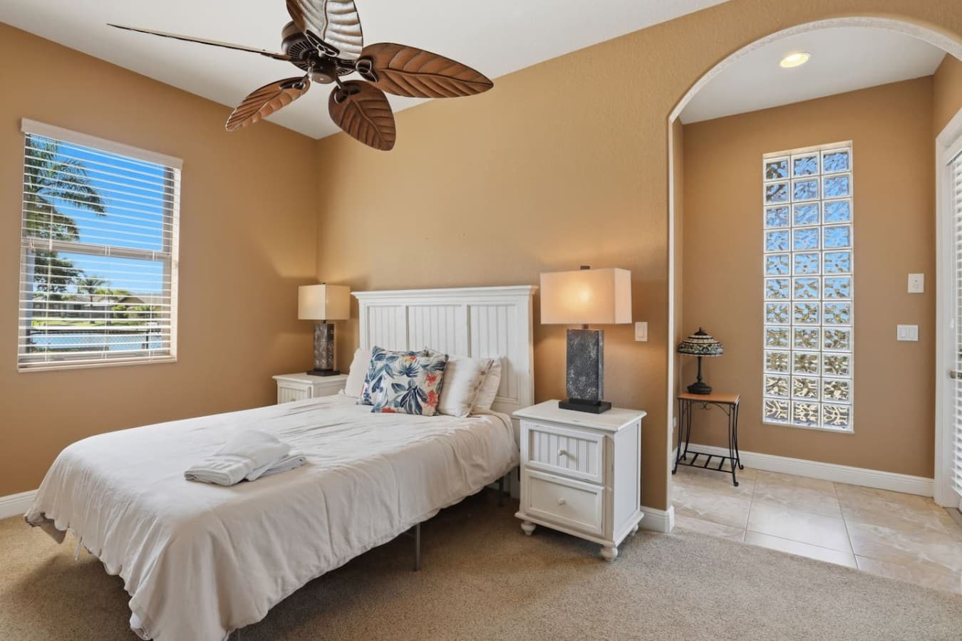 Comfortable guest bedroom with soft natural light and cozy coastal decor.