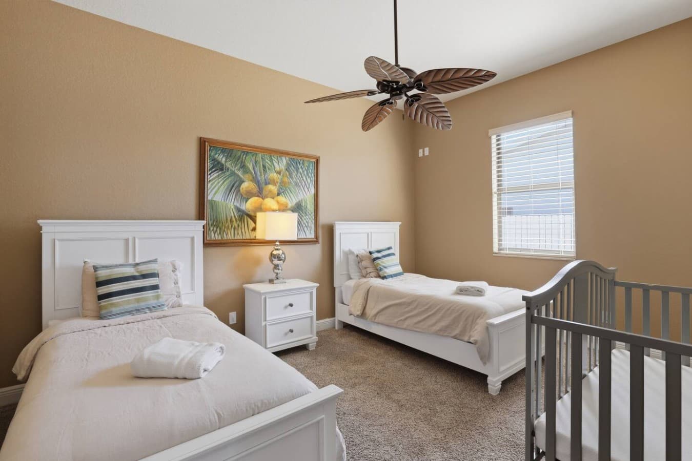 Bright guest bedroom with multiple beds perfect for families or groups.