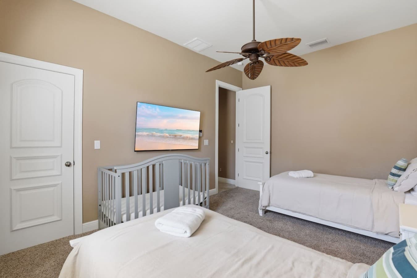 Spacious bedroom setup with comfortable sleeping arrangements and a mounted TV for added convenience.